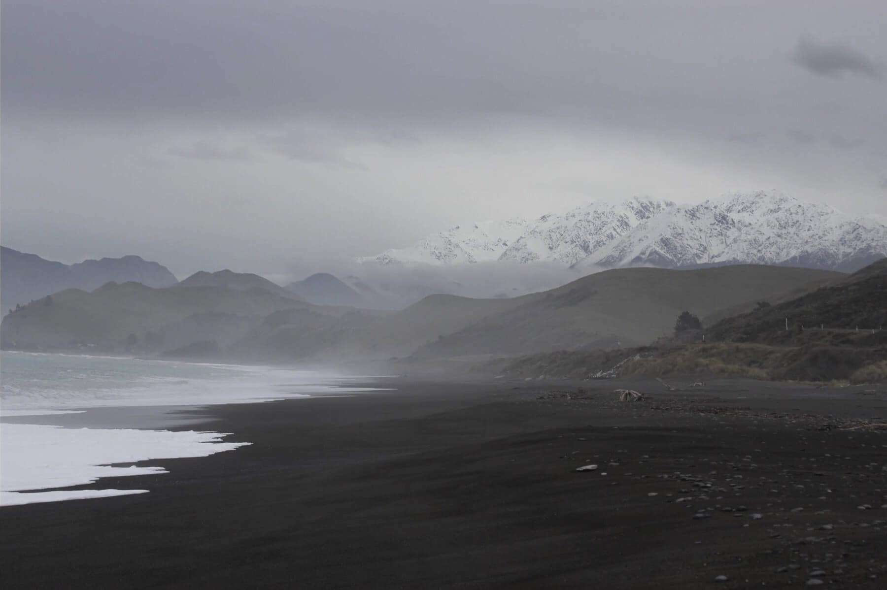 Black sand beach near Kaikoura in New Zealand. Find out if LivingSocial Escapes and Groupon Getaways are good deals or a scam in our Living Social & Groupon travel reviews.