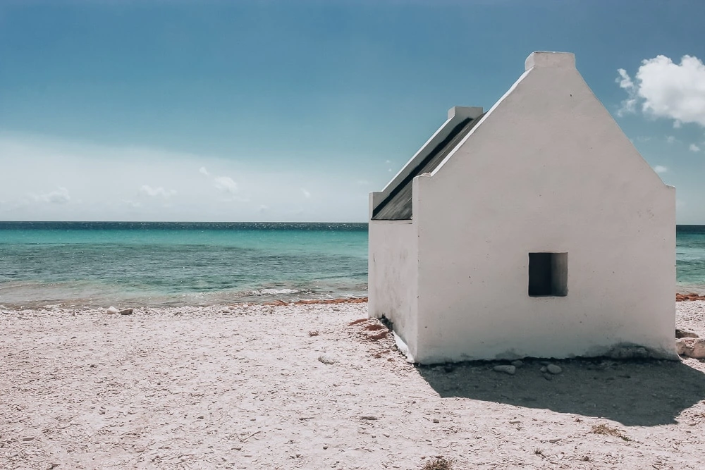 Former slave hut on the beach of Bonaire where the slaves lived to work the salt ponds. Find all the best things to do and see in Bonaire here.