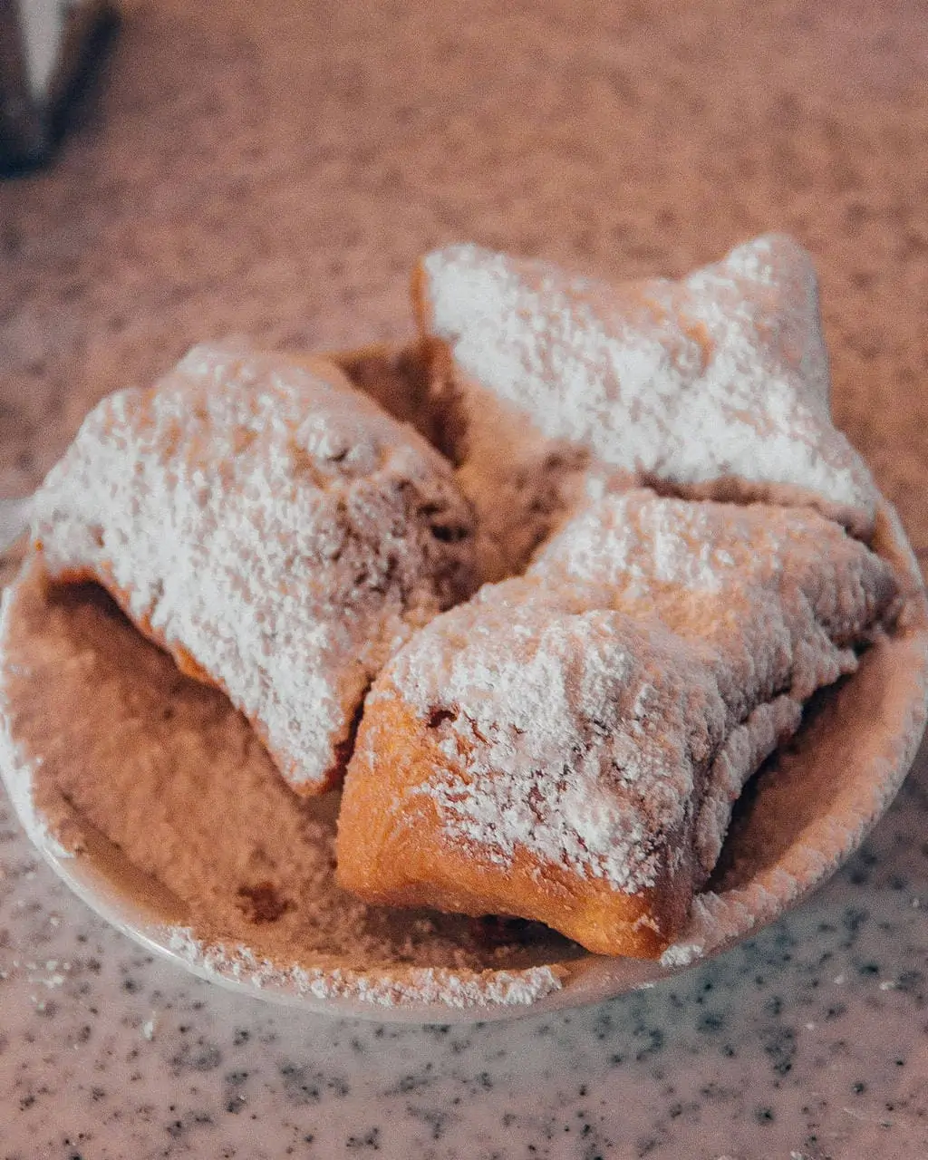 Beignets at Cafe du Monde in New Orleans Louisiana - a must eat food in New Orleans