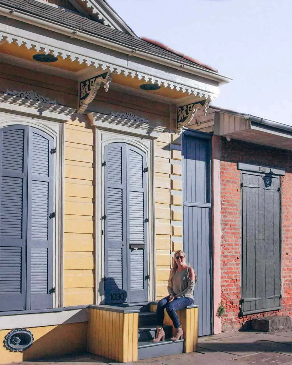 Woman sitting on steps in French Quarter in New Orleans