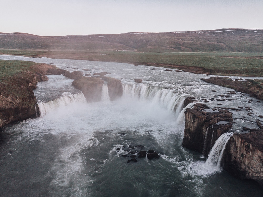 Drone shot of Godafoss Waterfall from above. Find the top 5 waterfalls in Iceland that you don't want to miss on a Ring Road road trip. 