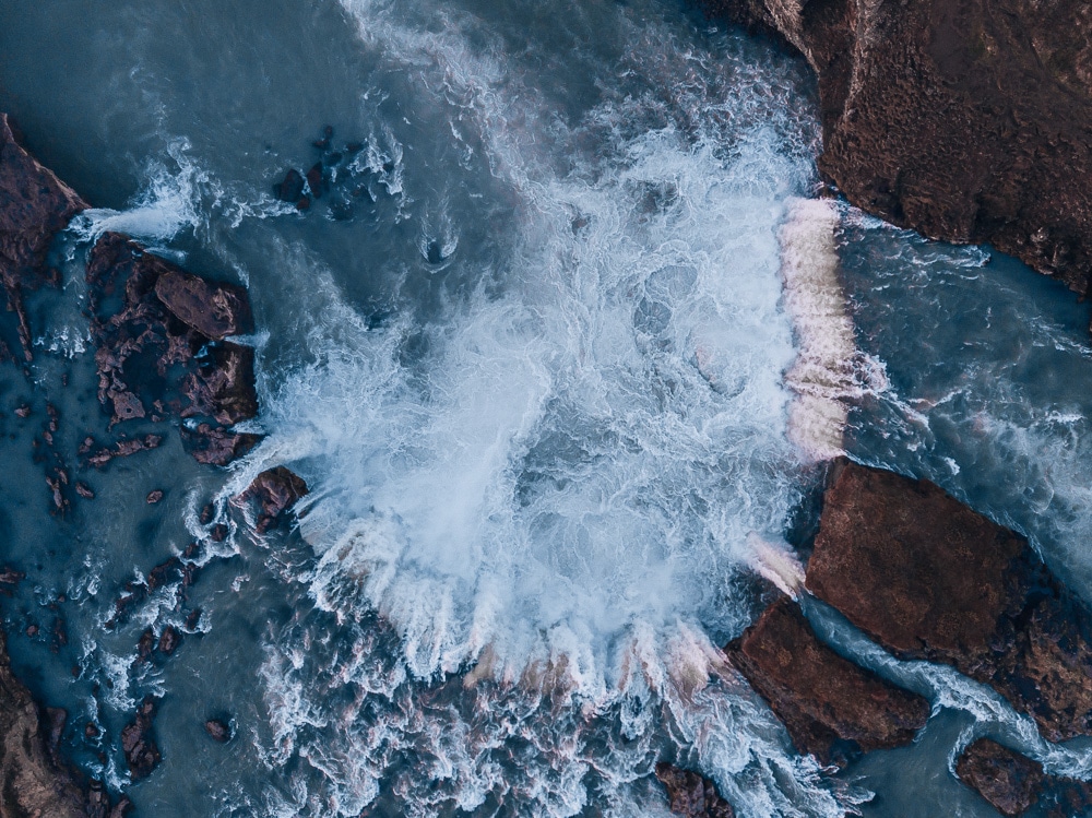 Drone shot of Godafoss Waterfall from above. Find the top 5 waterfalls in Iceland that you don't want to miss on a Ring Road road trip. 