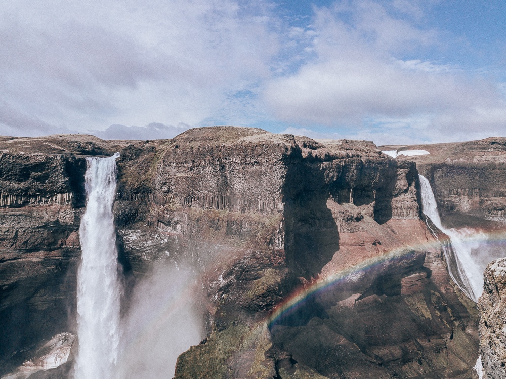 Haifoss Waterfall in Iceland with a rainbow in front of it. Find a full 6 day Iceland itinerary with a map here!