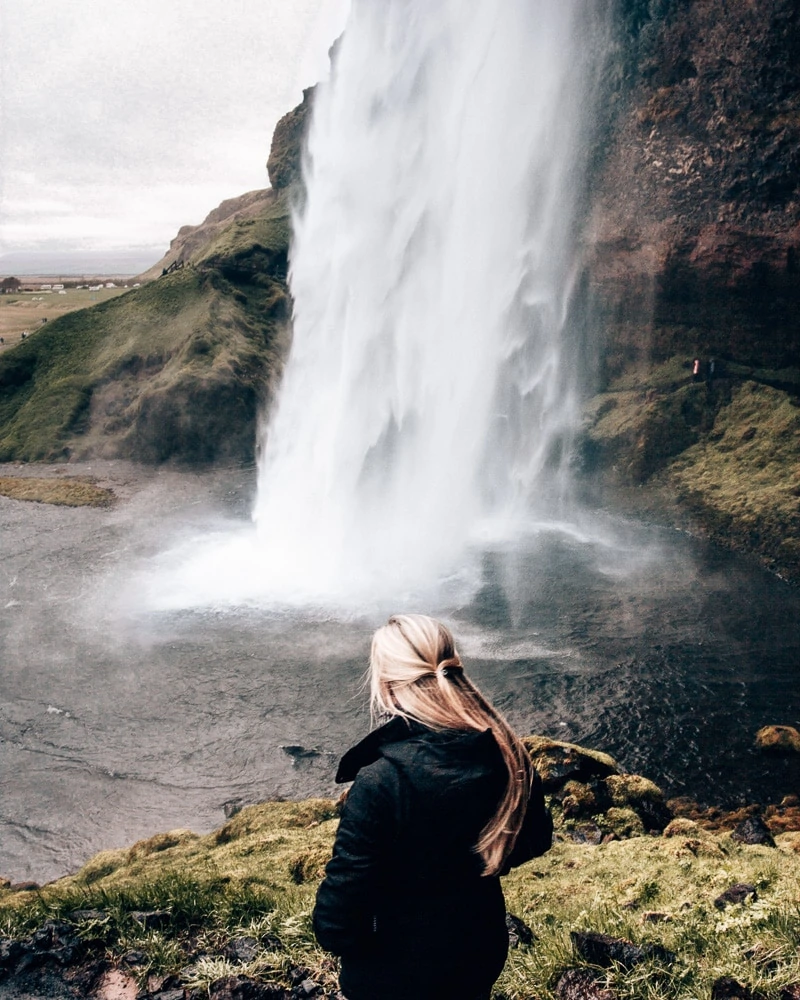 Looking at Seljalandsfoss waterfall in Iceland. Find the top 5 waterfalls in Iceland that you don't want to miss on a Ring Road road trip. 