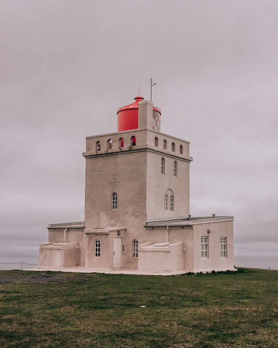 Dyrholaey's lighthouse near Vik and Reynisfajara in Iceland. Get our full 6 day Iceland itinerary for the ultimate Iceland road trip around Ring Road.
