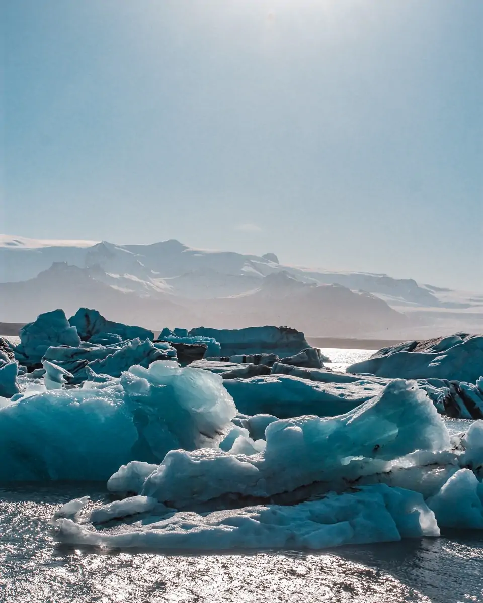 Pieces of glacier floating in Jokulsarlon Glacier Lagoon in Iceland in the summer. Get our full road trip itinerary for Iceland in 6 days here.