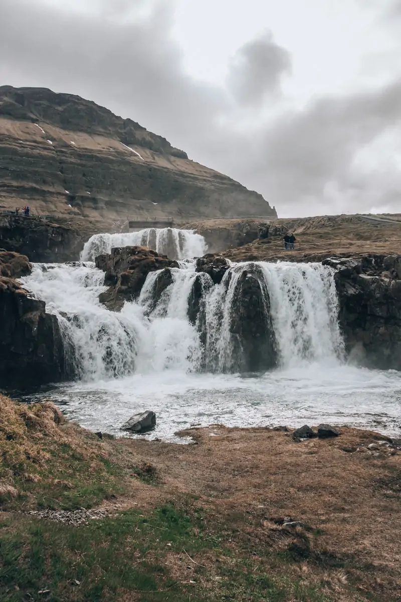 Kirkjufellsfoss in Iceland in summer. Find all the best Iceland road trip stops with these Iceland travel tips and itinerary.