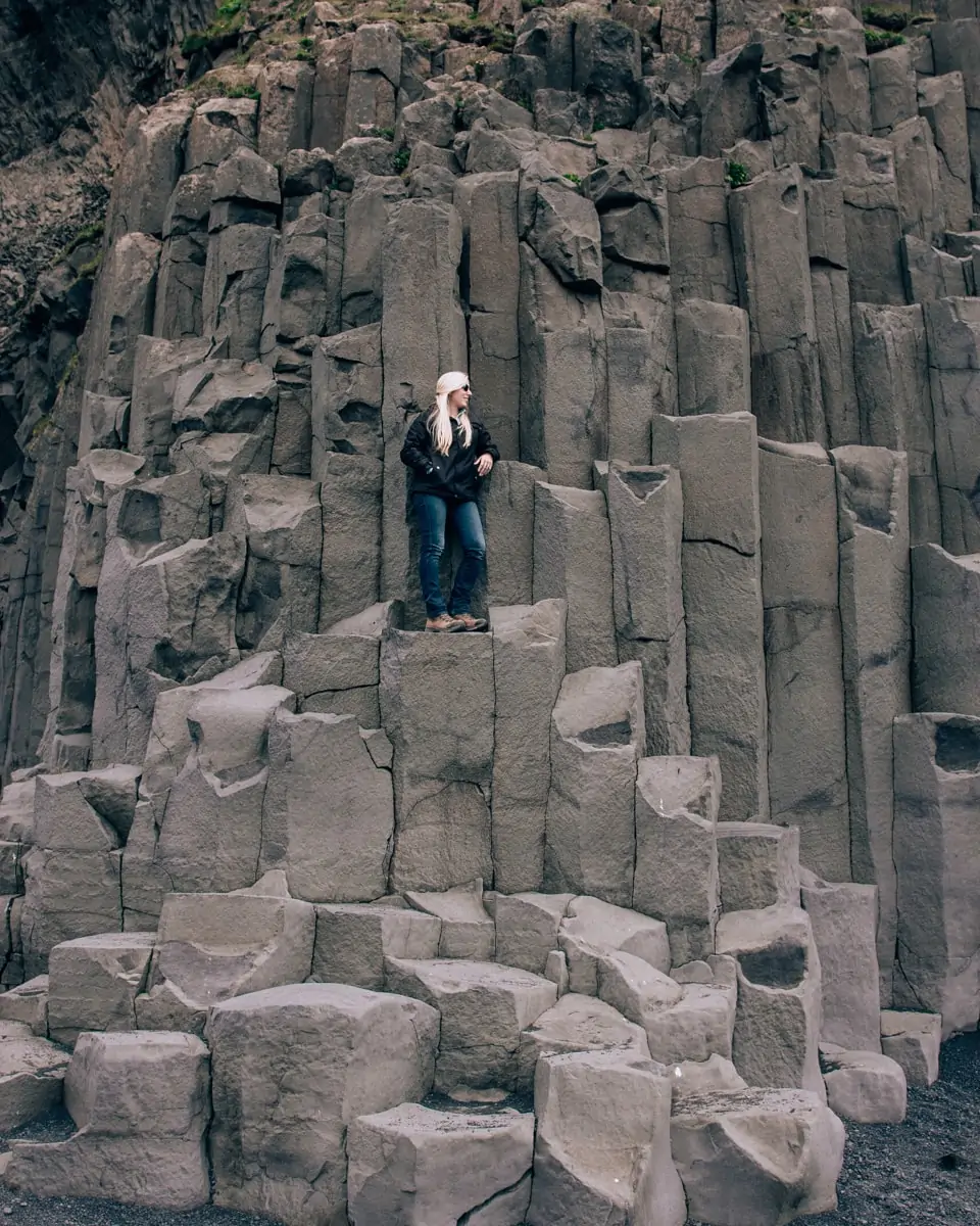 Standing on the Basalt columns at Reynisfajara Beach near Vik in Iceland. All the best photo spots in Iceland are here on our 6 day Iceland itinerary (get a free map too!)