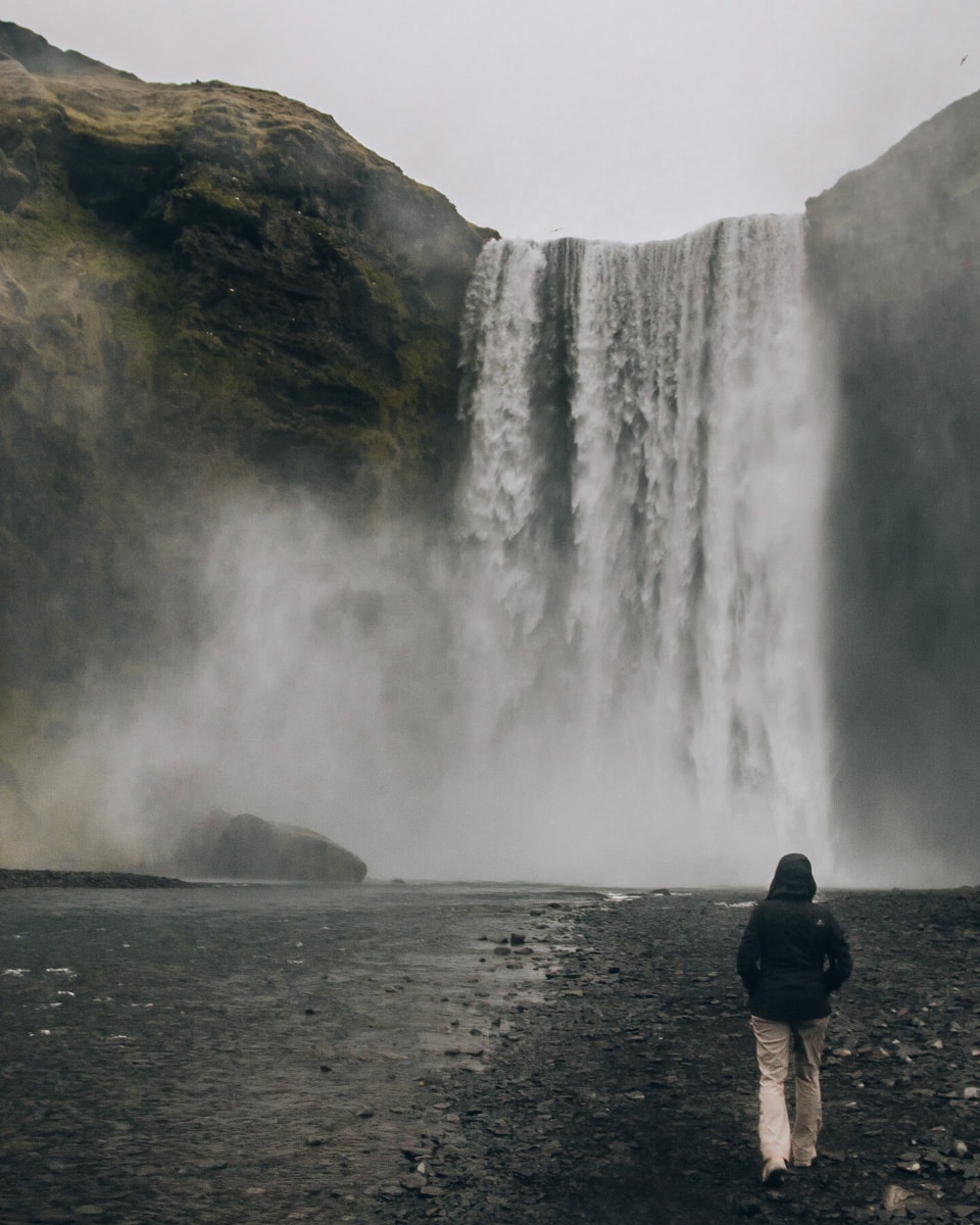 Walking up to Skogafoss Waterfall in Iceland means getting soaked in the mist. Find all of our best Iceland travel tips in our 6 day Iceland itinerary. #iceland