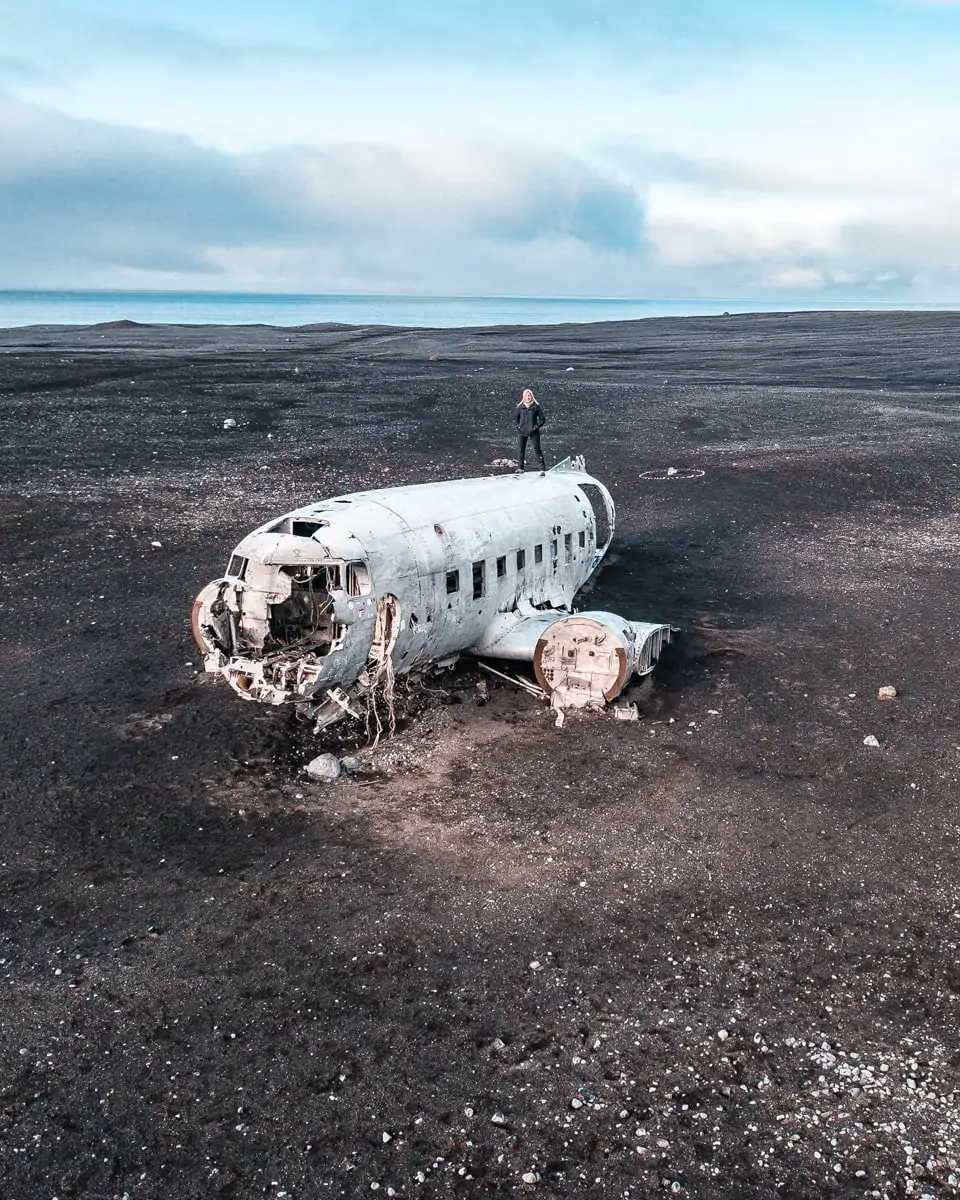 Solheimasandur DC-3 Plane Wreck in Iceland on a black sand beach. Full Iceland travel guide with a 6 day itinerary here.