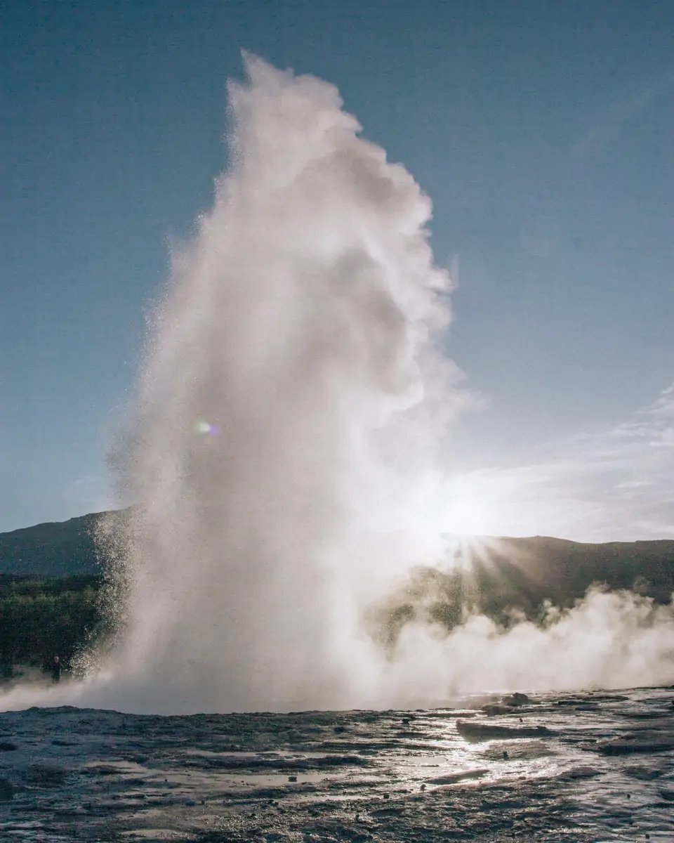 Strokkur erupting at Geysir, one of the Golden Circle's main attractions. Click here for a perfect 6 day itinerary for Ring Road in Iceland with a free map!