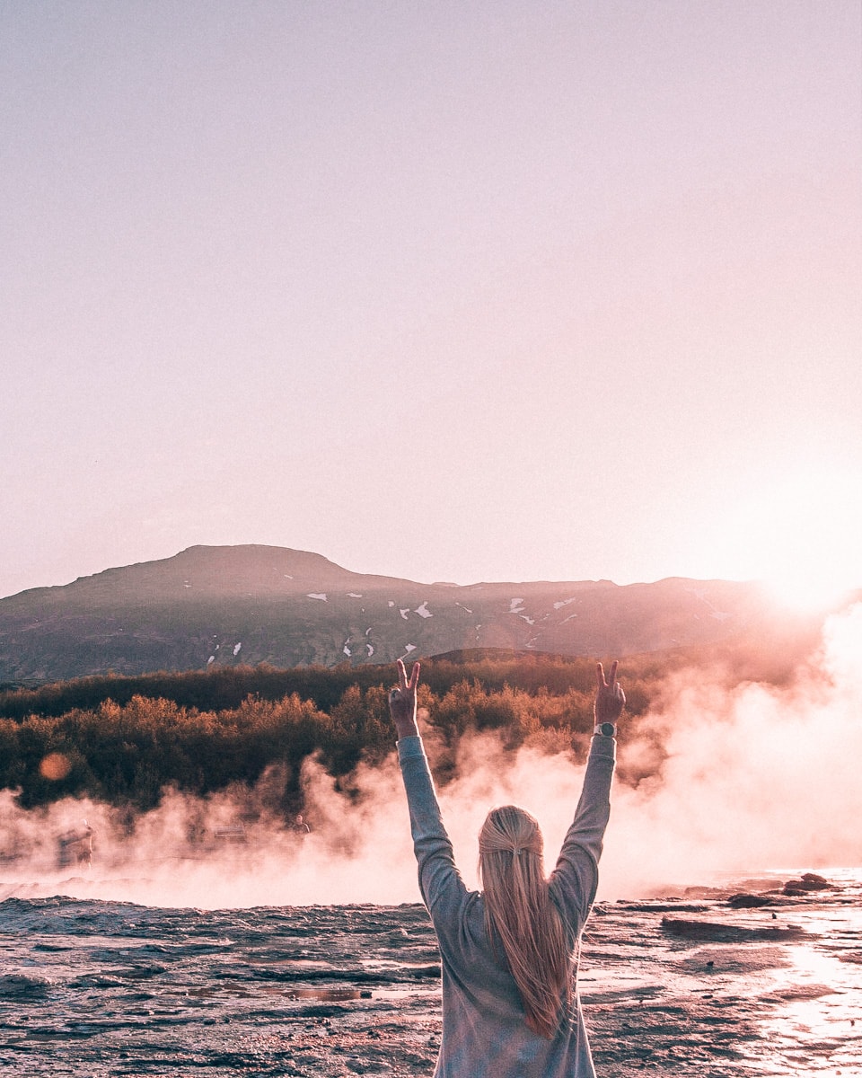 Waiting for Strokkur to erupt at sunset in Geysir on Iceland's Golden Circle. Find a map and full guide to 6 days in Iceland on an epic road trip here.