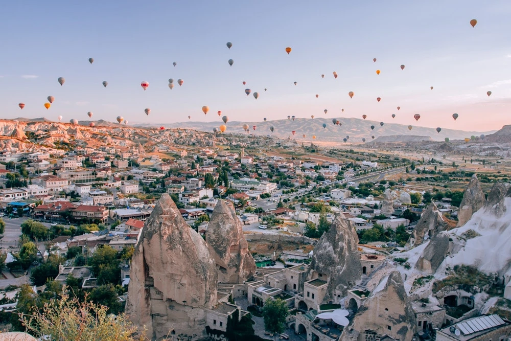 View from Sunset Point in Goreme at sunrise. Click for a 3 day itinerary and guide to Cappadocia's must see locations and most Instagramable places.