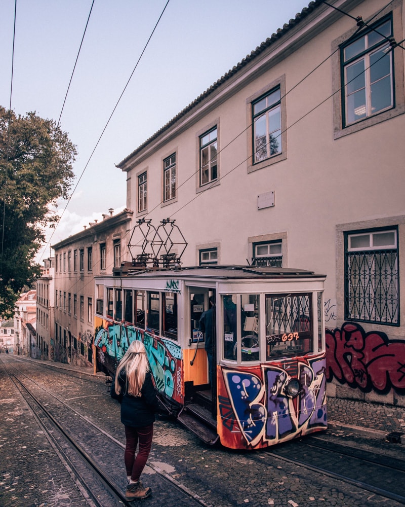 Ascensor da Gloria in Lisbon Portugal covered in graffiti. Find the most Instagrammable places in Lisbon, Portgual, here with a free map!