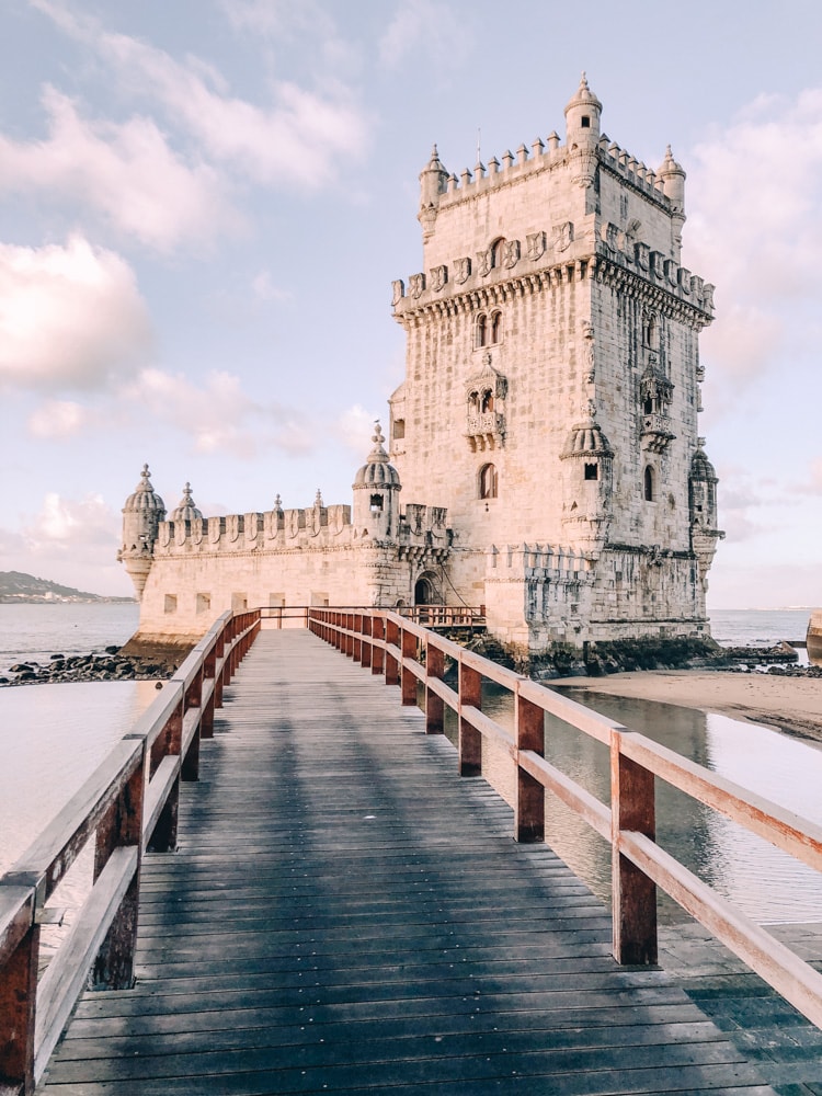 The bridge to Belem Tower near sunrise. Find a list of Lisbon's most Instagrammable photo locations plus Lisbon travel tips and a free map here.