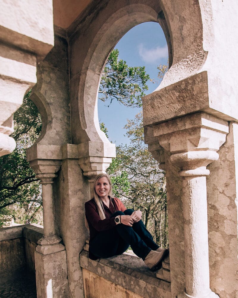 Woman sitting in a window at Pena Palace in Sintra