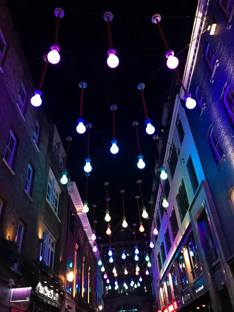Carnaby Street at night. Find the perfect 3 day itinerary for London with Instagrammable places to see, places to eat, and places to stay.