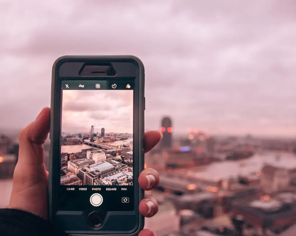 Taking a picture of the view from the top of the dome of St. Paul's Cathedral near sunset. Check out this 3 day London itinerary for the best things to do in London and the best London photo spots.