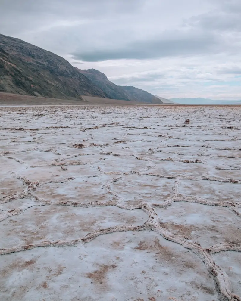 Along the walk to the salt flats in Badwater Basin, you will see dirt mixed with the sand until about half a mile out. Find a full one day itinerary for Death Valley including where to stay, what to see and do, and when to visit.