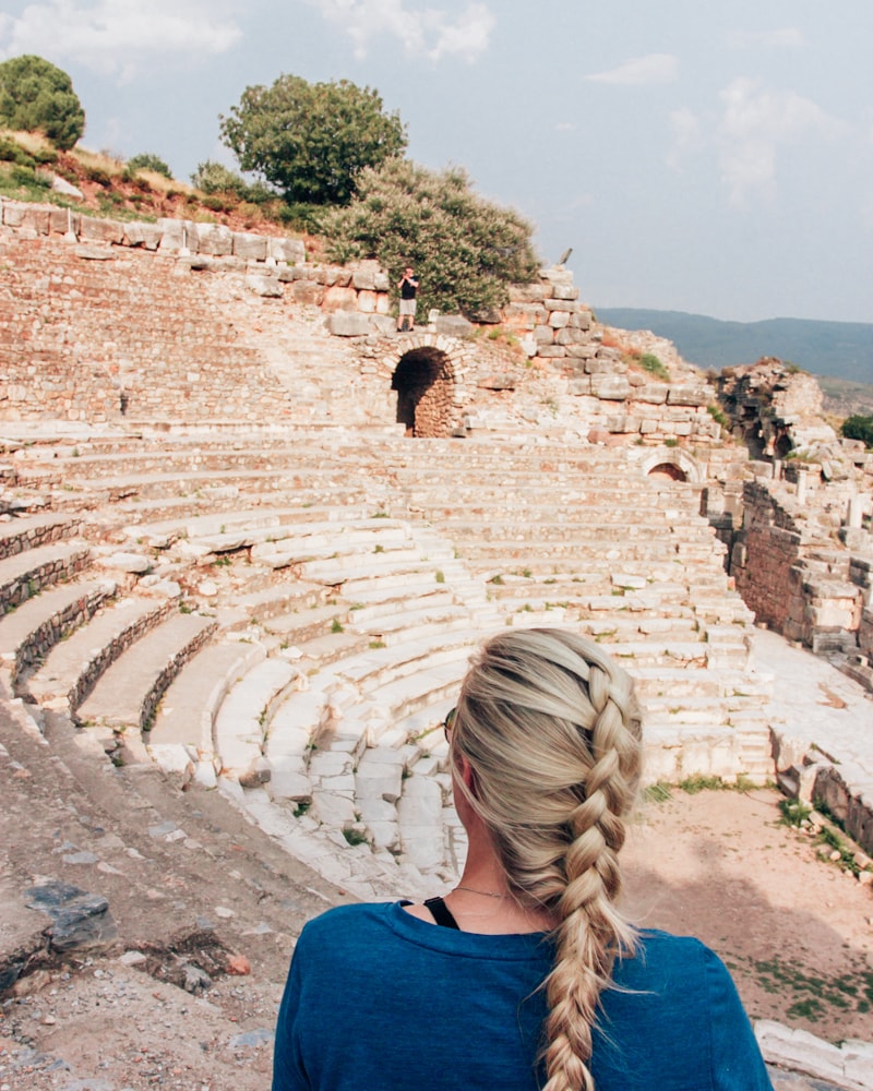 Sitting in the Odeon Theater in Epheus takes you back in time. Find a full one day itinerary with everything you need to know about visiting the ancient ruins of Ephesus in Turkey here.