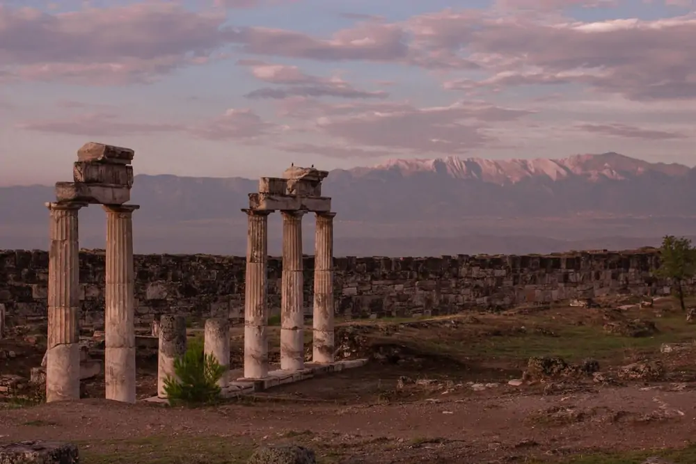 Ruins of Hierapolis at sunrise. The Ultimate Guide to Visiting Pamukkale gives you all the information you need about what you can really expect, when to go, where to stay, and more.