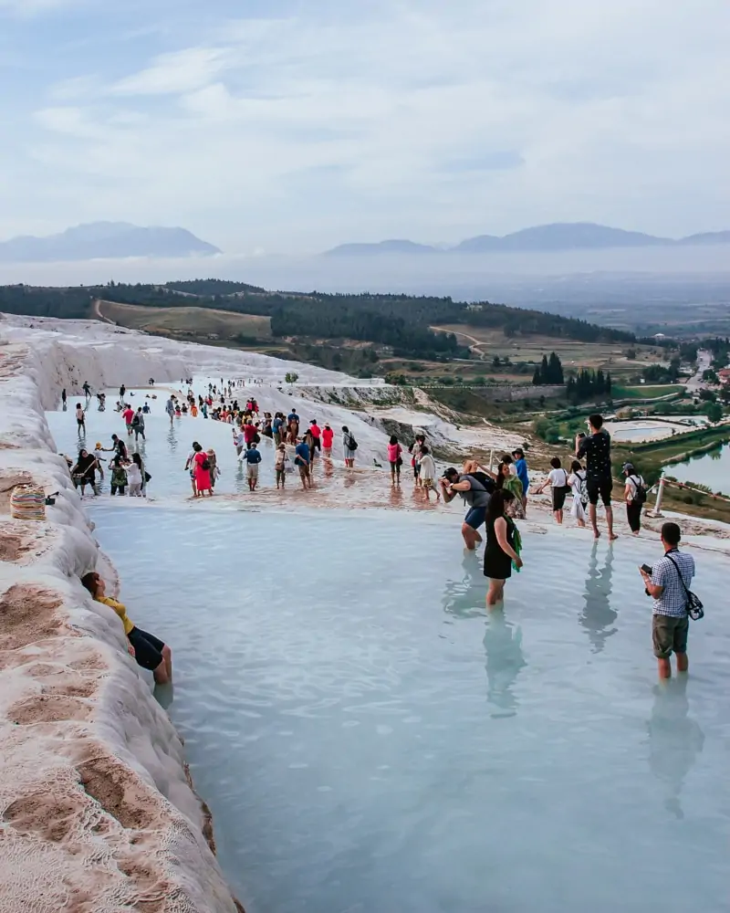This is what Pamukkale really looks like most of the day, but the crowds mostly stay at the top. The Ultimate Guide to Visiting Pamukkale gives you all the information you need about what you can really expect, when to go, where to stay, and more.