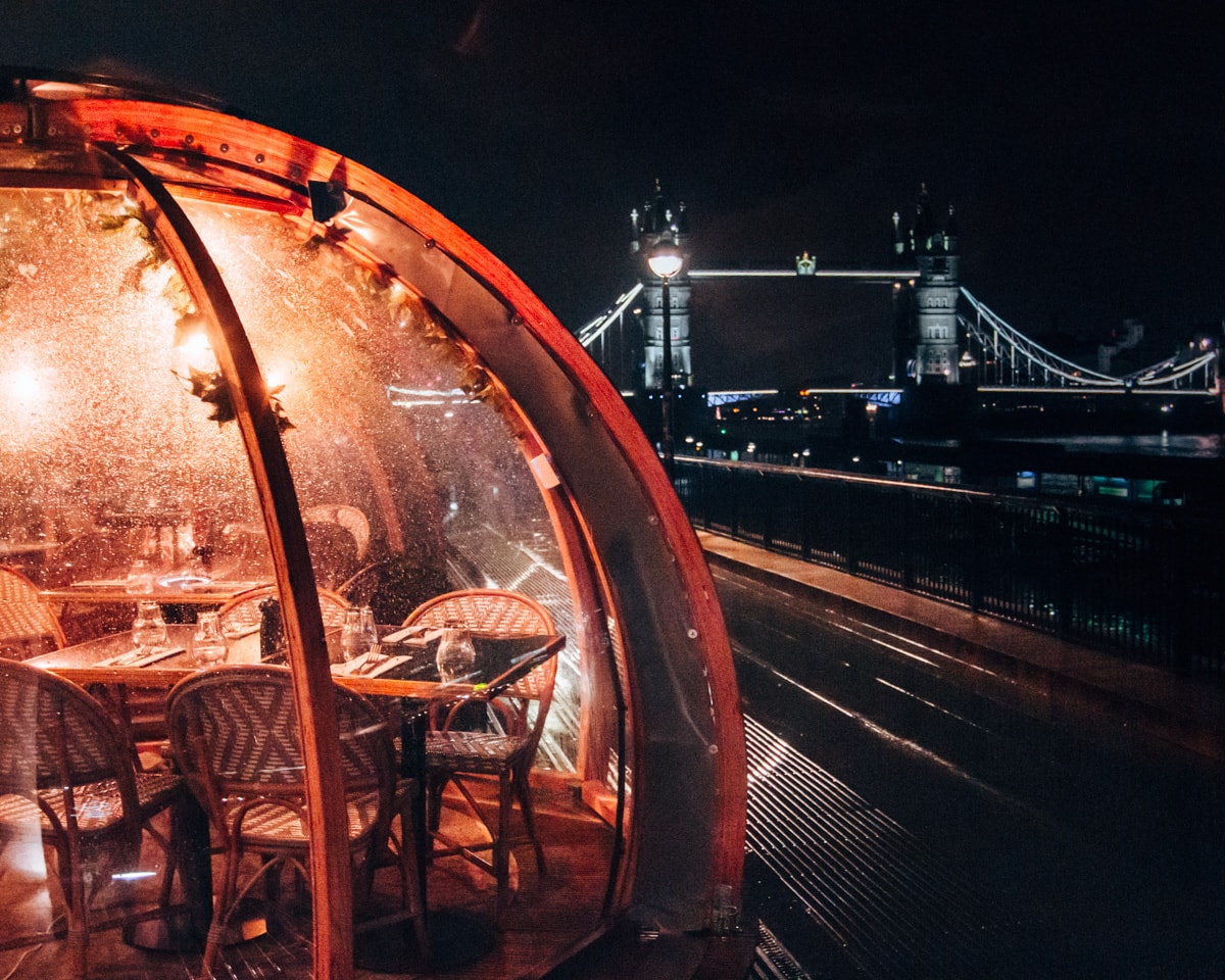 Coppa Club igloos at night with the Tower Bridge in the distance