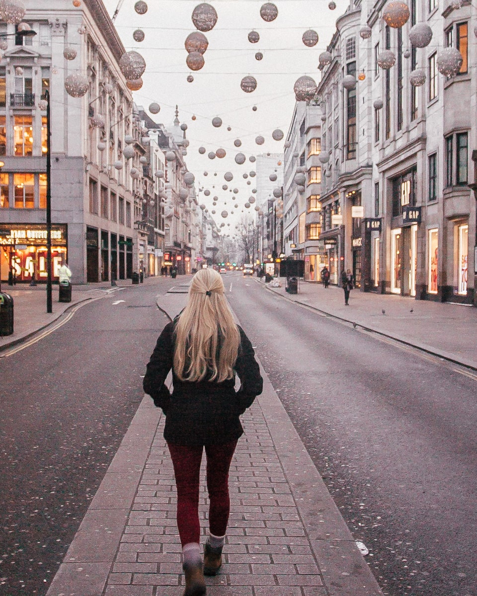 Walking down the median in Oxford Street near sunrise with the Christmas lights still on, one of the best Christmas lights in London