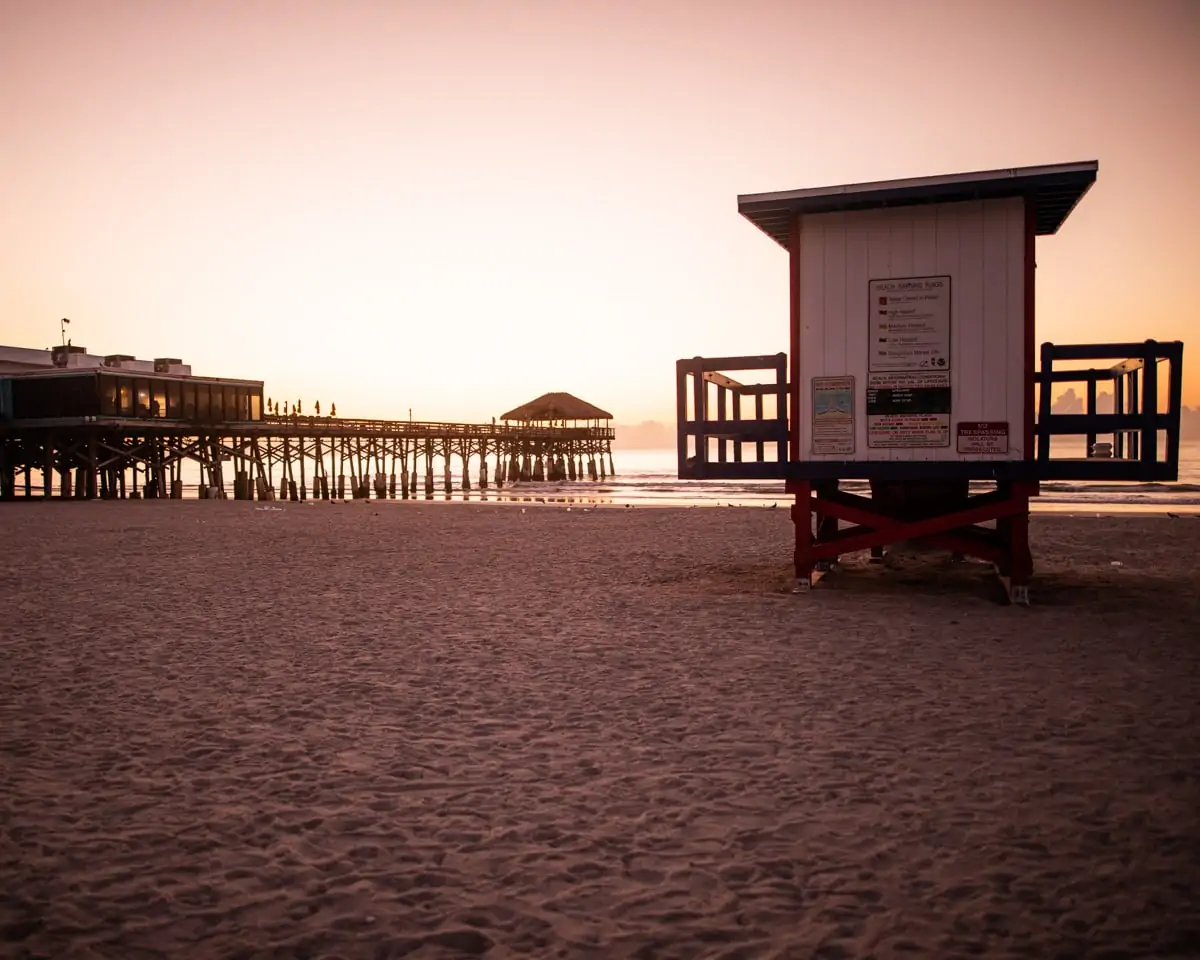 A lifeguard shack next to Westgate Cocoa Beach Pier at sunrise