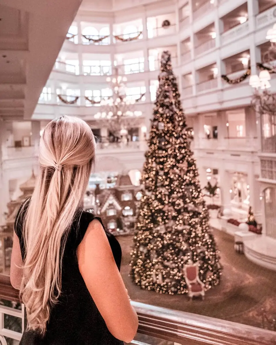 Looking down on the lobby of the Grand Floridian with the Christmas tree from the second level balcony. Get a list of the top things to do in Orlando for Christmas here.