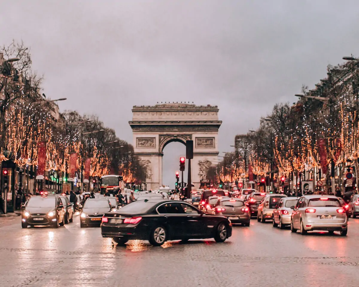 The Champs Elysees in Paris in winter with Christmas lights. Get a full guide to Paris in winter and celebrating New Year's in Paris here.