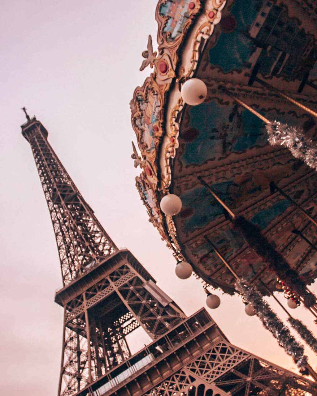 The Eiffel Tower and the carousel across the street by the Pont D'lena in Paris. Get a guide to the best photo spots in Paris at New Year's here.