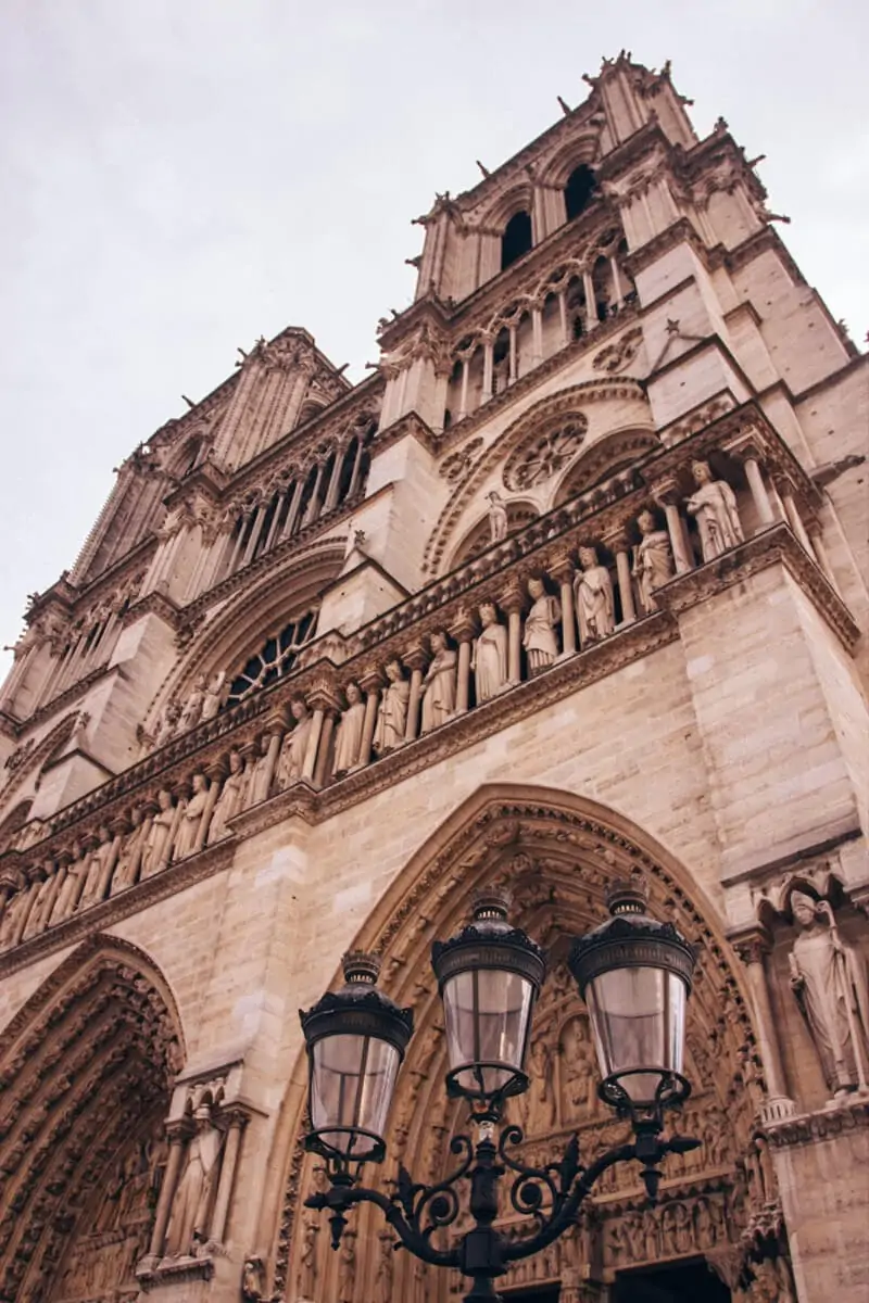 The front of Notre Dame in Paris. Get travel tips for winter in Paris with this guide to New Year's in Paris.