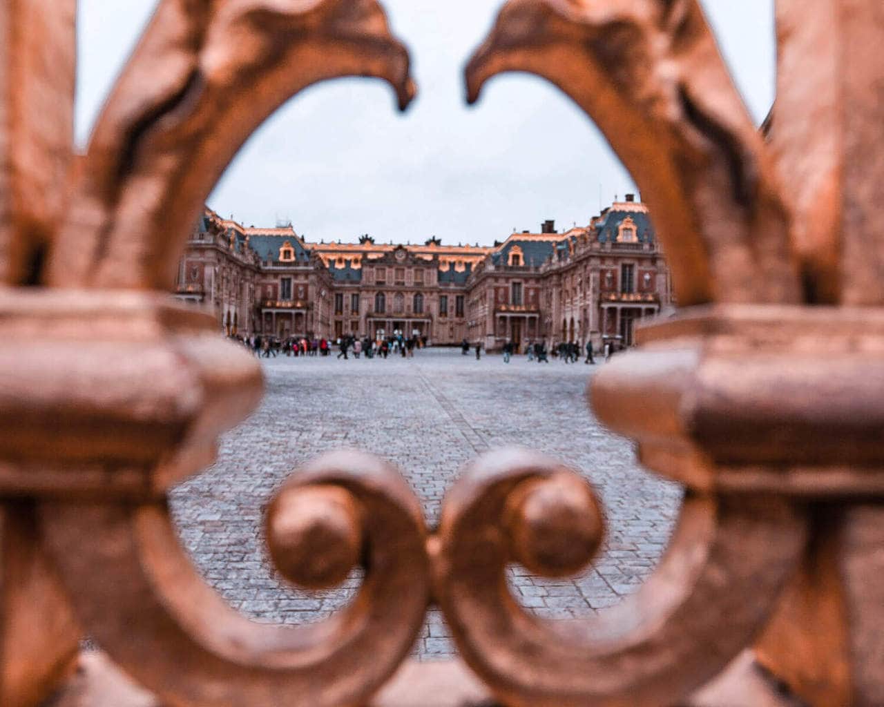 Looking through the gates at Versailles Palace in Paris, France. Find Paris travel tips in this guide to New Year's in Paris.