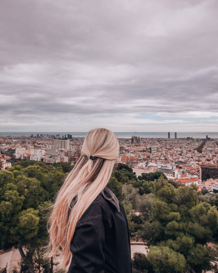 A woman looking out over Barcelona from the free zone at Park Guell