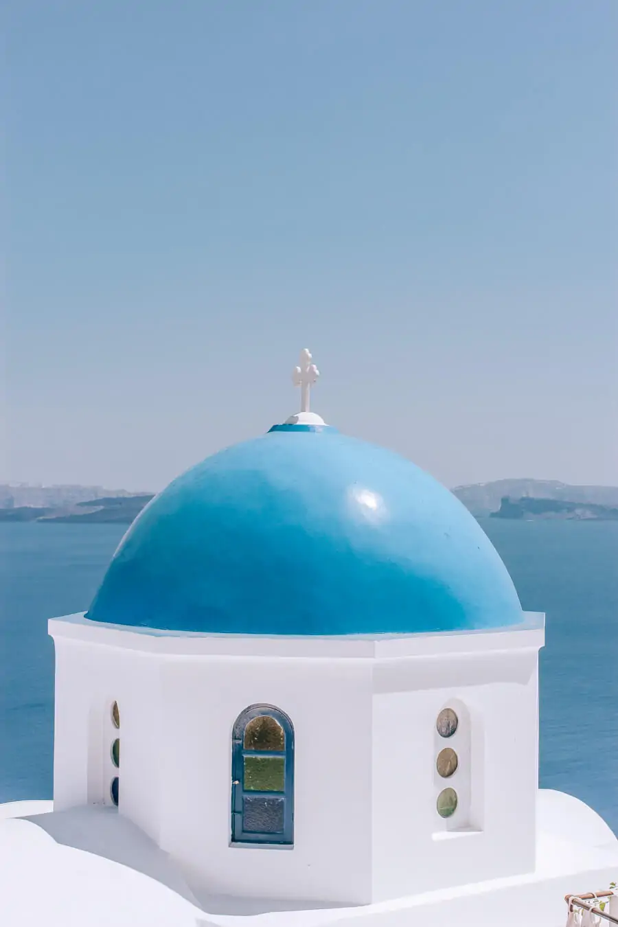 A church with a blue dome in Santorini Greece