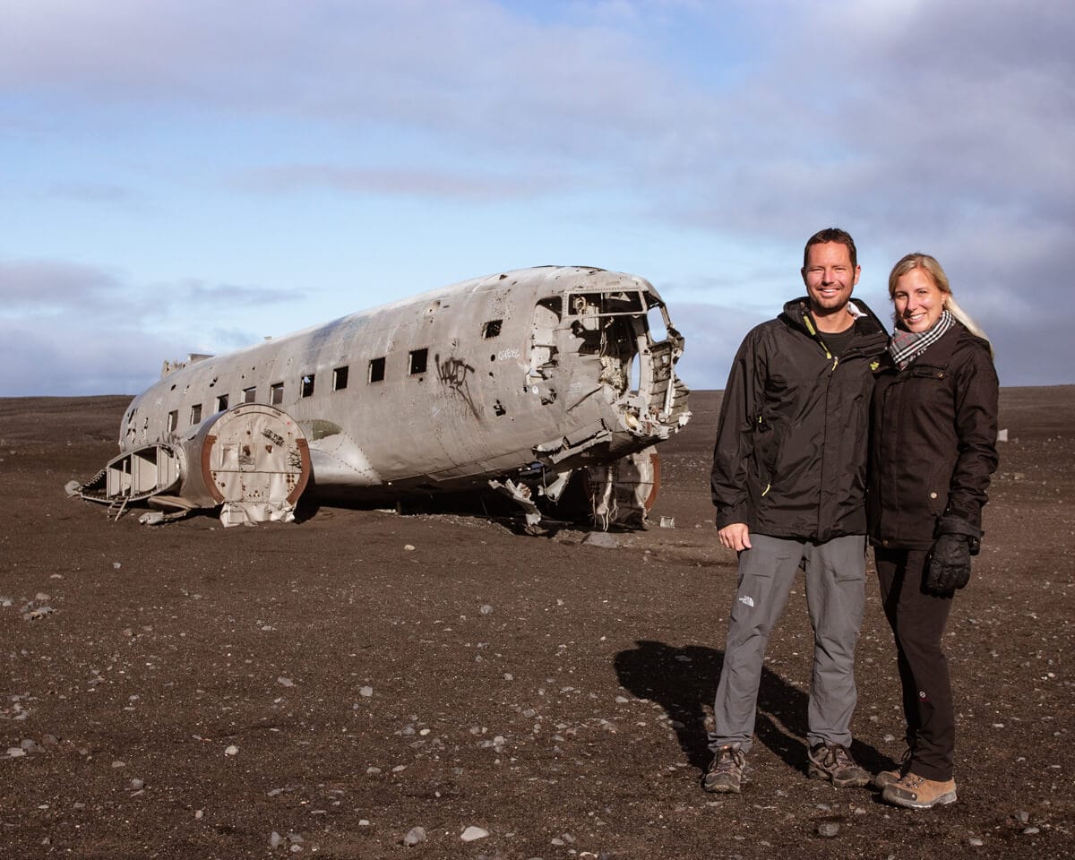 A couple in front of the Sólheimasandur plane crash