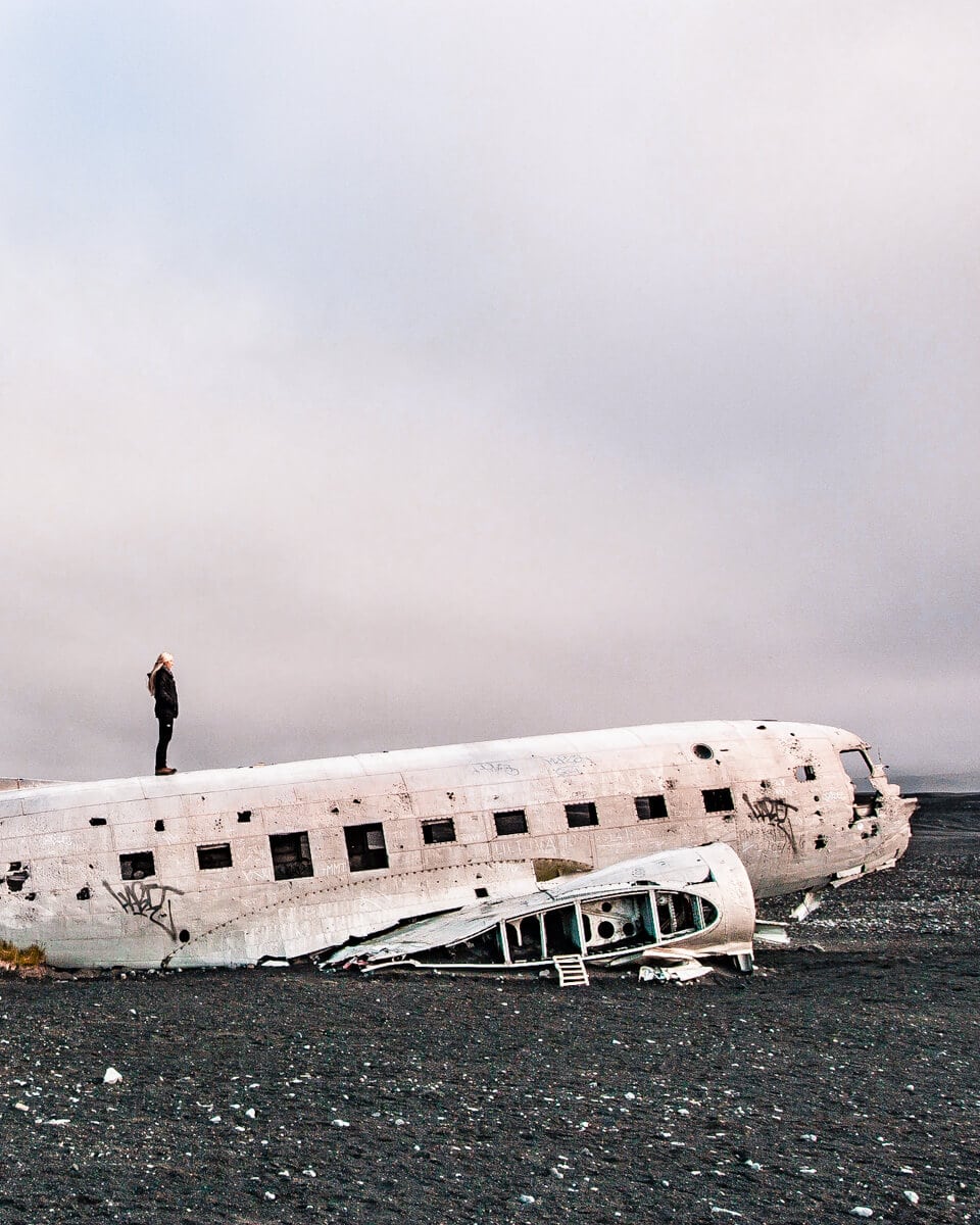 A woman on top of the Sólheimasandur plane crash