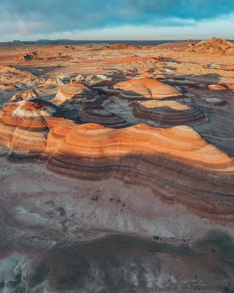 sunset at bentonite hills lights the hills up orange and red