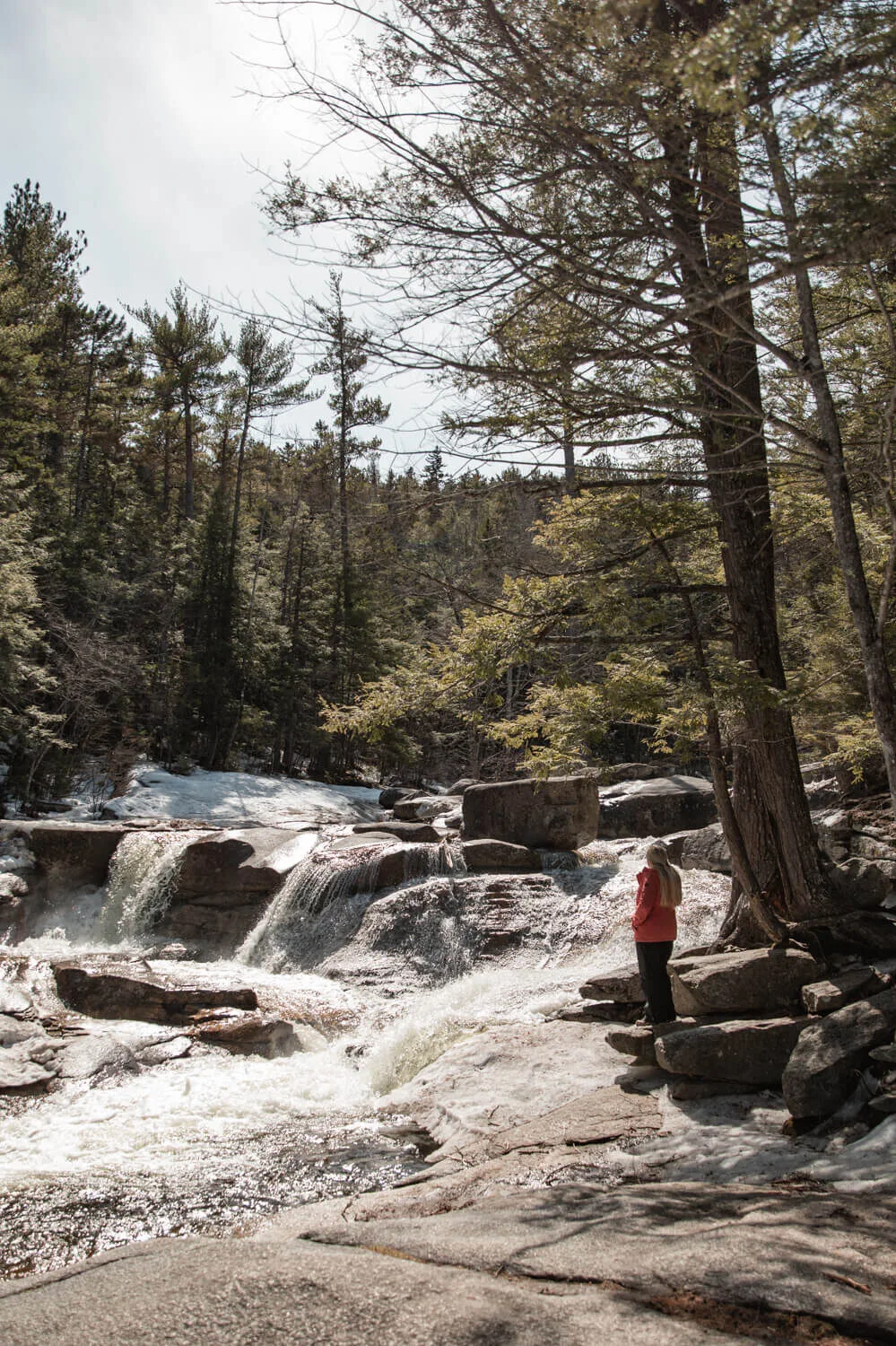 woman looking at Diana's Baths waterfall in New England