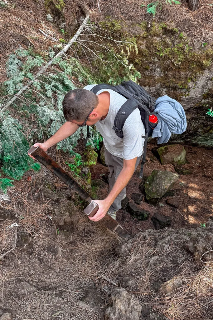 Man climbing into Skylight Cave