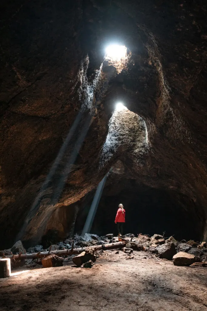 woman in skylight cave lava tube in oregon