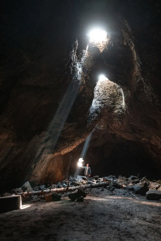 man in skylight cave in a sunbeam