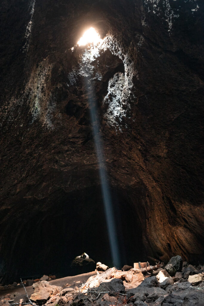 narrow ray of light in skylight cave lava cave in Oregon
