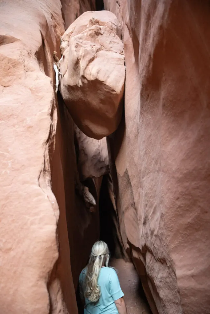 woman and chockstone in leprechaun canyon