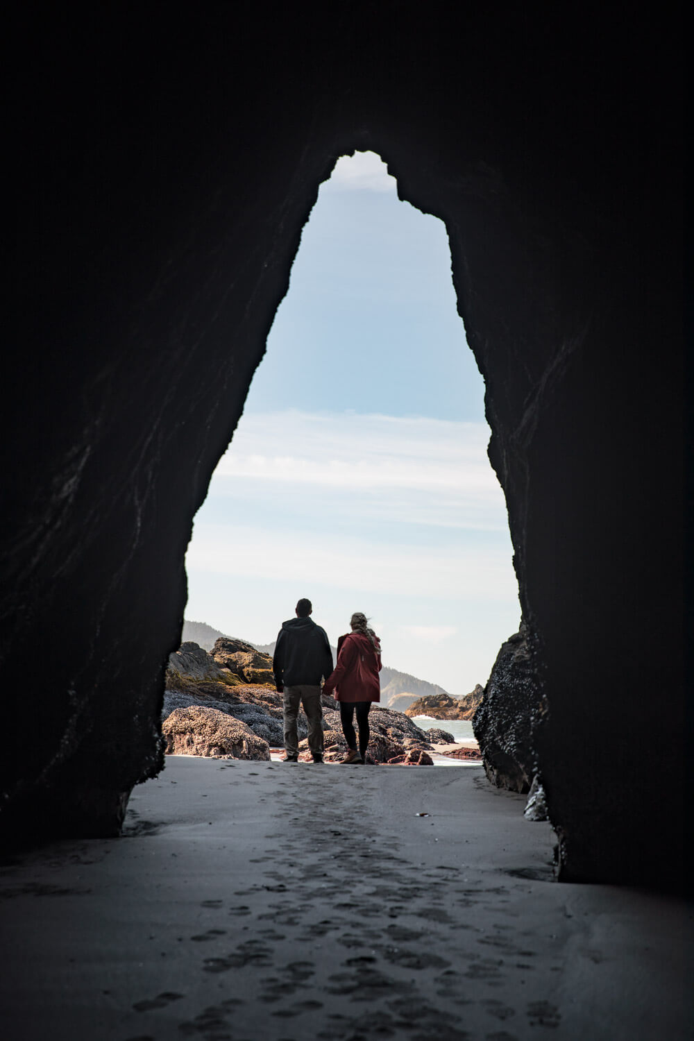 couple in sea cave in secret beach brookings oregon