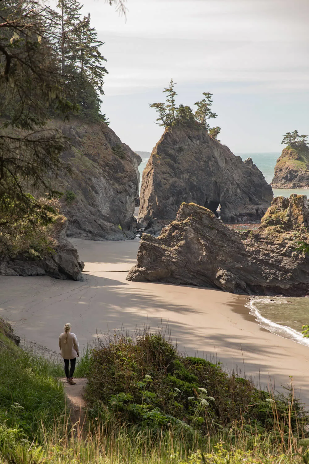 woman looking out at secret beach oregon