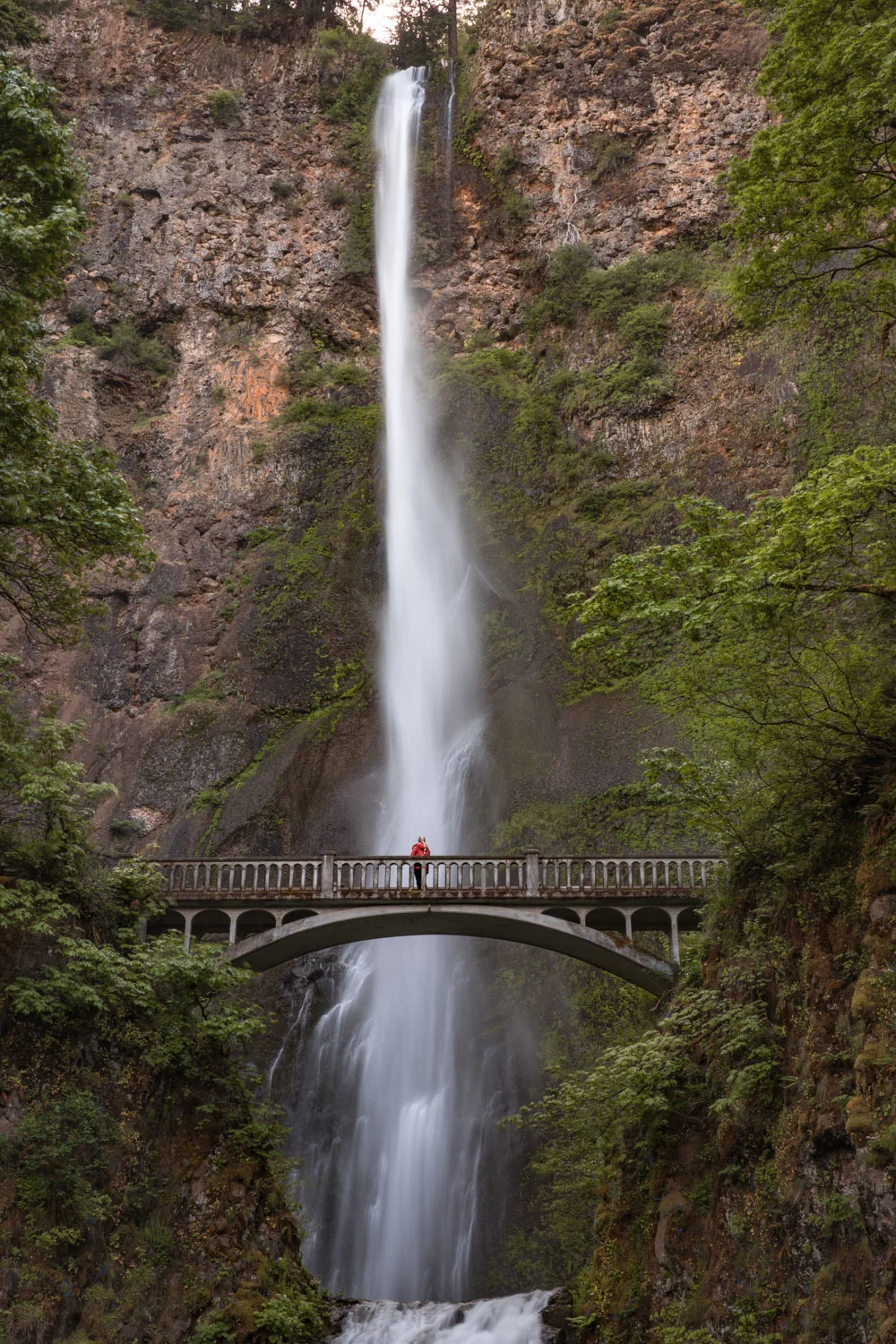 woman on a bridge across a waterfall in Portland Oregon - Multnomah Falls