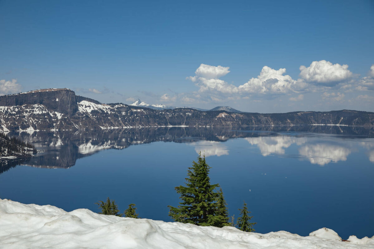 crater lake with snow in may
