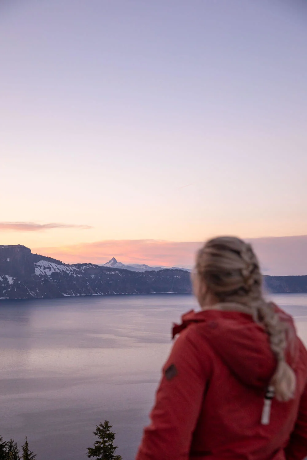 woman looking out at crater lake and mount thielsen